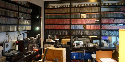 Das Studio von Leroy Ehrenreich. Zu sehen sind zahlreiche Tonträger die an der Wand aufgereiht sind.
