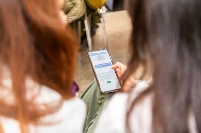 two people looking at a mobile phone screen